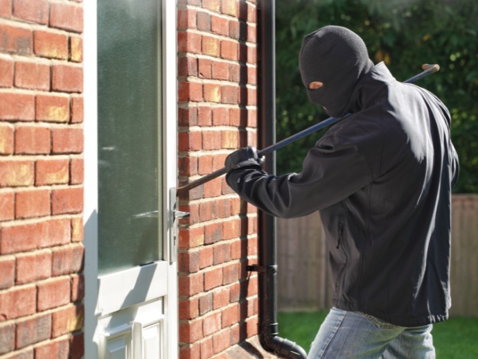 Burglar Breaking a door in the day